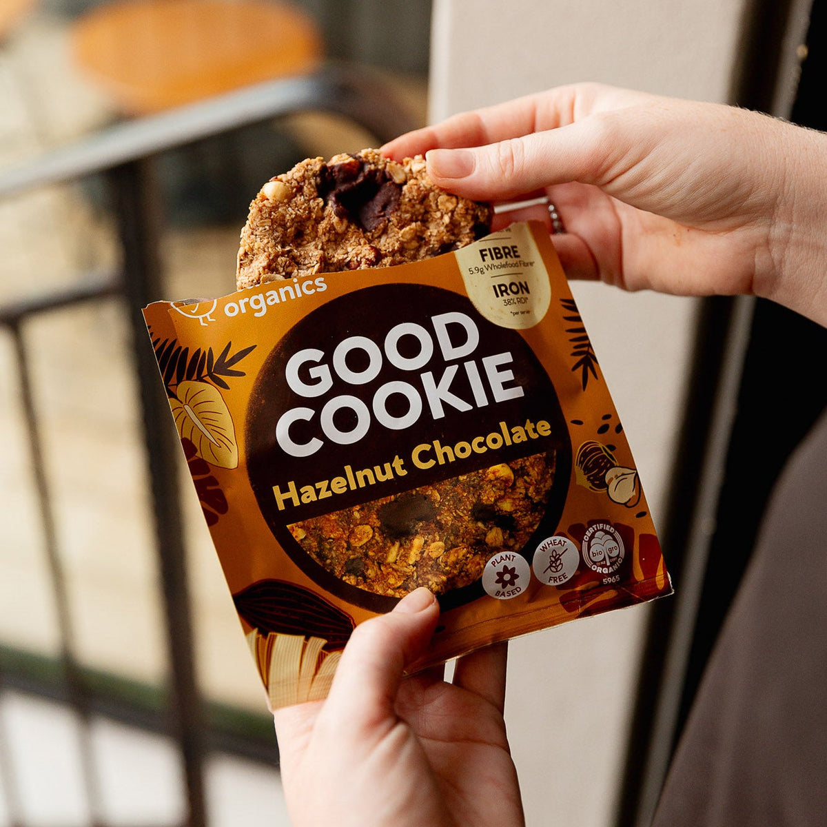 Person holding a 'Good Cookie' Hazelnut Chocolate cookie package